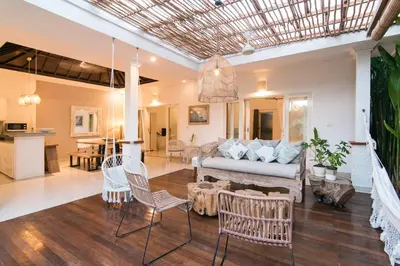 a living room with a couch and chairs at Incredible villa near Atlas beach club Berawa in Canggu