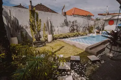 a backyard with a swimming pool in a house at Bohemian Kasya Villa Bali in Seminyak