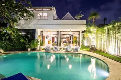 a swimming pool in front of a house at Monroe 3BR Luxury Villa Seminyak BREAKFAST INCL Netflix Private Pool 900m to Beach in Seminyak