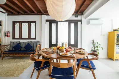 a dining room with a wooden table and chairs at Monroe 3BR Luxury Villa Seminyak BREAKFAST INCL Netflix Private Pool 900m to Beach in Seminyak