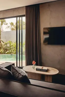 a living room with a couch and a table at Je Ne Sais Quoi Seminyak in Seminyak