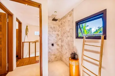 a room with a television on a wall at Villa Waikiki - Brand New 4BDR with huge Pool in Seminyak