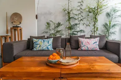 a living room with a couch and a wooden coffee table at Villa Ziba in Seminyak