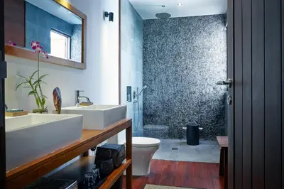 a bathroom with a white sink and a toilet at Villa Ziba in Seminyak