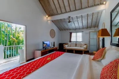 a bedroom with a large bed and a living room at Villa Rama Sita - 100m from Eat Street, 3BR in Seminyak