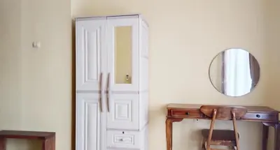 a door in a room with a table and a mirror at Tambak Sari Villa in Jimbaran