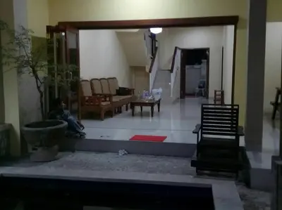 a living room with a person sitting on the floor at Tambak Sari Villa in Jimbaran