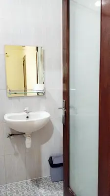 a bathroom with a sink and a mirror at Tambak Sari Villa in Jimbaran