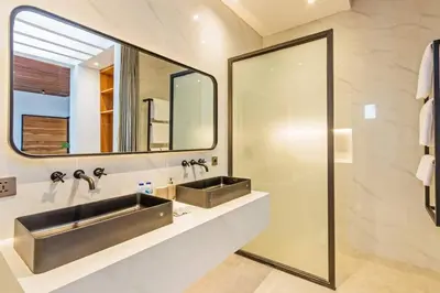 a bathroom with two sinks and a mirror at Manresa Villa Bali 4 in Canggu