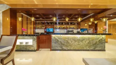 a bar with a marble counter in a room at City of Aventus Hotel - Denpasar in Denpasar