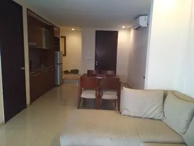 a living room with a couch and a dining room table at LBV Seminyak Apartment in Seminyak