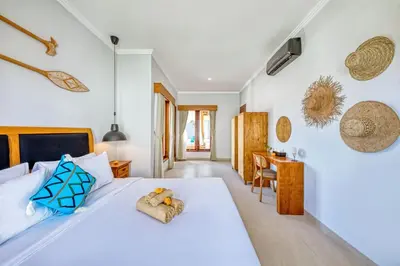 a bedroom with a white bed with a teddy bear on it at Freshly Renovated 3 BD Homey Central Villa in Seminyak
