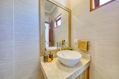 a bathroom with a bowl sink and a mirror at Freshly Renovated 3 BD Homey Central Villa in Seminyak