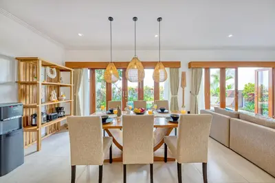 a dining room with a table and chairs at Freshly Renovated 3 BD Homey Central Villa in Seminyak
