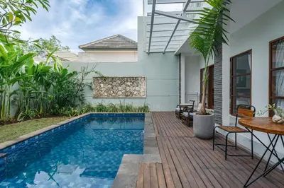 a swimming pool in the backyard of a house at Villa Putih Jimbaran in Jimbaran