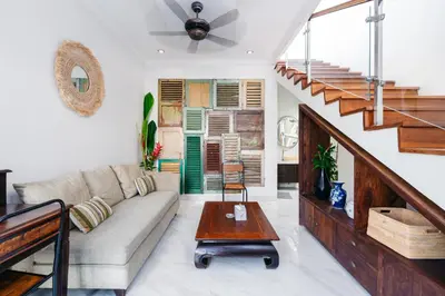 a living room with a couch and a table at Villa Putih Jimbaran in Jimbaran