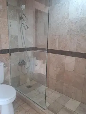 a bathroom with a shower with a toilet at Two bedroom suite Apartment, Jayakarta,Legian, Unit 6420, block A ,4th floor in Seminyak