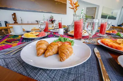 a table with a plate of food with croissants on it at Villa Becca 4 Bedroom at Seminyak near to the Beach in Seminyak