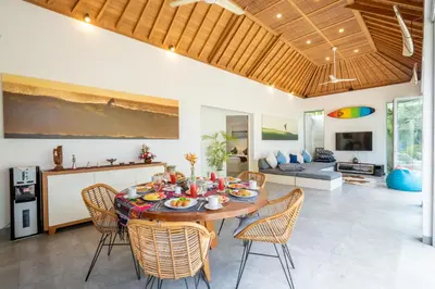 a dining room and living room with a table and chairs at Villa Becca 4 Bedroom at Seminyak near to the Beach in Seminyak