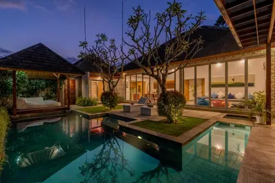 a house with a swimming pool in front of it at Villa Becca 4 Bedroom at Seminyak near to the Beach in Seminyak