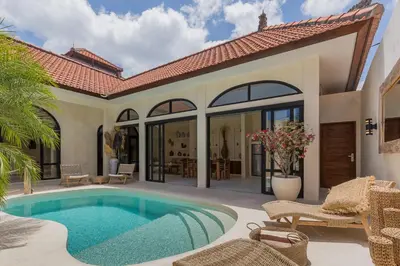 a villa with a swimming pool and a patio at VILLA SALEYA with JACUZZI in Canggu