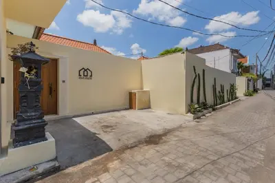a white building with a gate and a street at VILLA SALEYA with JACUZZI in Canggu