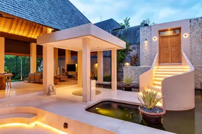 a house with a koi pond in the yard at Navya Villas in Canggu