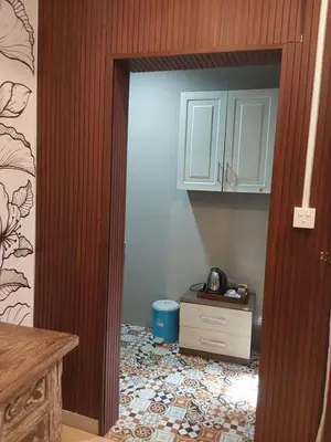 an open door to a kitchen with a table at Buratwangi Tropis House in Kerobokan