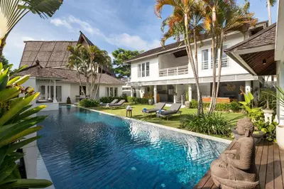 a swimming pool in front of a villa at Kerta Rama Seminyak by Kerta Living in Seminyak