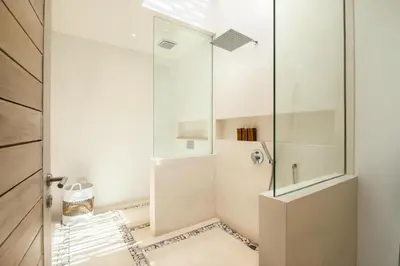 a bathroom with a shower with a glass door at Chic 4BR Villa, Canggu Hub, 800m to Beach Bliss in Canggu