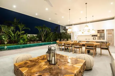 an open kitchen and dining room with a table and chairs at Chic 4BR Villa, Canggu Hub, 800m to Beach Bliss in Canggu