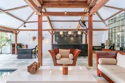 an open living room with a table and chairs at Villa Gambar - Comfortable Modern Mix 3BR Villa with Large Private Pool, 10 Minutes to the Beach in Canggu
