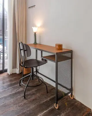 a desk with a chair and a lamp in a room at Villa Gambar - Comfortable Modern Mix 3BR Villa with Large Private Pool, 10 Minutes to the Beach in Canggu