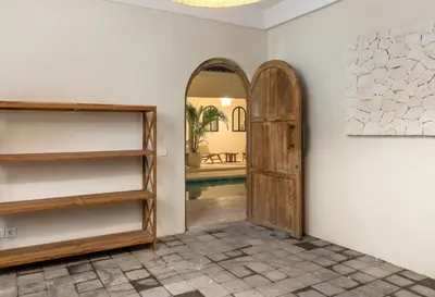 a hallway with a door and a mirror at Casa Adem - Modern & Trendy 3BR Villa in Seminyak, 10 Minutes to the Beach with Private Pool in Seminyak