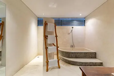a bathroom with a bath tub and a sink at Villa Ace - Modern 2BR Villa in Seminyak with Spacious Bedrooms, Bathtub & Private Pool in Seminyak