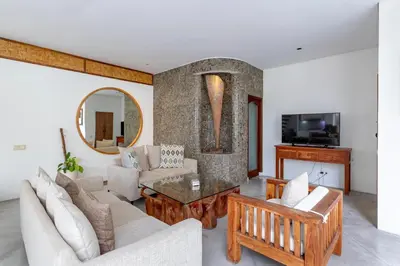 a living room with a couch and a table at Villa Ace - Modern 2BR Villa in Seminyak with Spacious Bedrooms, Bathtub & Private Pool in Seminyak