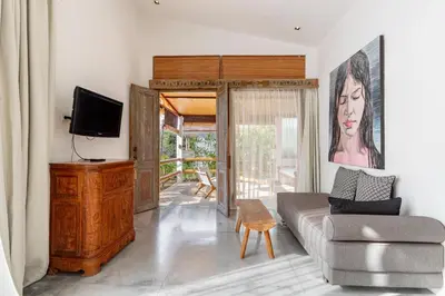 a living room with a couch and a tv at Villa Ace - Modern 2BR Villa in Seminyak with Spacious Bedrooms, Bathtub & Private Pool in Seminyak