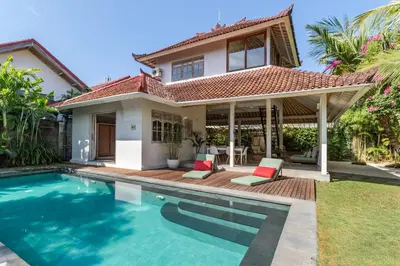 a villa with a swimming pool in front of a house at Villa Telma - Charming 2BR Villa in Central Seminyak, Walking Distance to Eat Street in Seminyak