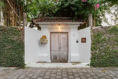 a small white building with a wooden door at Villa Telma - Charming 2BR Villa in Central Seminyak, Walking Distance to Eat Street in Seminyak