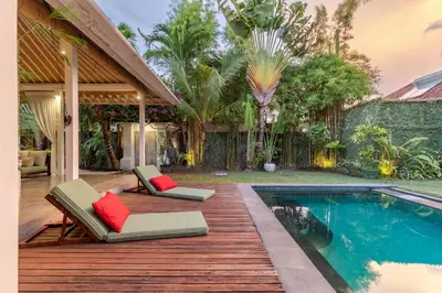 a patio with two chairs and a swimming pool at Villa Telma - Charming 2BR Villa in Central Seminyak, Walking Distance to Eat Street in Seminyak