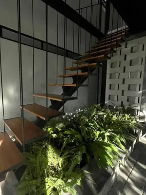 a staircase in a building with some plants at The Drupadi Apartments Studio Peka in Seminyak