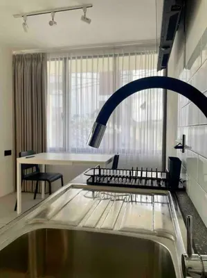 a kitchen with a faucet and a sink at The Drupadi Apartments Studio Peka in Seminyak