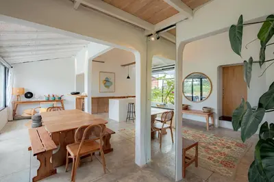 a dining room and living room with a table and chairs at House Sawah - Beautiful & Stylish 3BR Home with Jacuzzi Near Umalas and Seminyak in Kerobokan