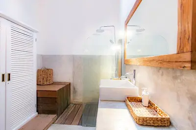 a bathroom with a sink and a mirror at House Sawah - Beautiful & Stylish 3BR Home with Jacuzzi Near Umalas and Seminyak in Kerobokan