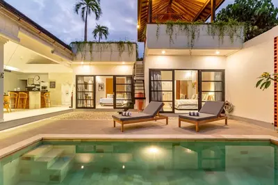 a villa with a swimming pool and a house at Villa Elea - Bright & Modern 2BR Villa in Seminyak with Private Pool and Sunset Rooftop in Seminyak