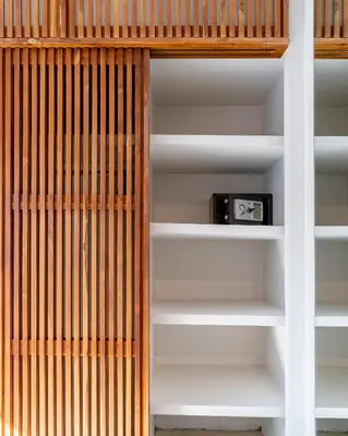 a book shelf with a clock on it at Villa Elea - Bright & Modern 2BR Villa in Seminyak with Private Pool and Sunset Rooftop in Seminyak