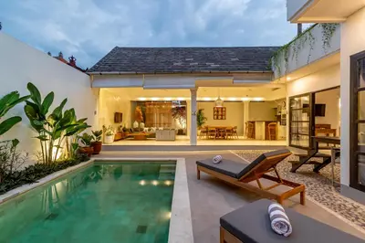 a house with a swimming pool and a patio at Villa Elea - Bright & Modern 2BR Villa in Seminyak with Private Pool and Sunset Rooftop in Seminyak