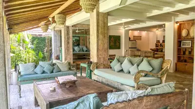 a living room with couches and a table at Villa Nak - Charming 4BR Family-Friendly Villa, Walking Distance to Seminyak Beach in Seminyak