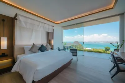 a bedroom with a bed and a large window at Beyond The Sea - Luxe Sea View Villa in Jimbaran in Jimbaran