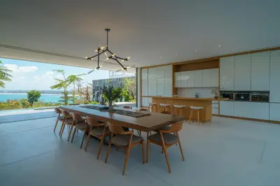 an open kitchen and dining room with a table and chairs at Beyond The Sea - Luxe Sea View Villa in Jimbaran in Jimbaran